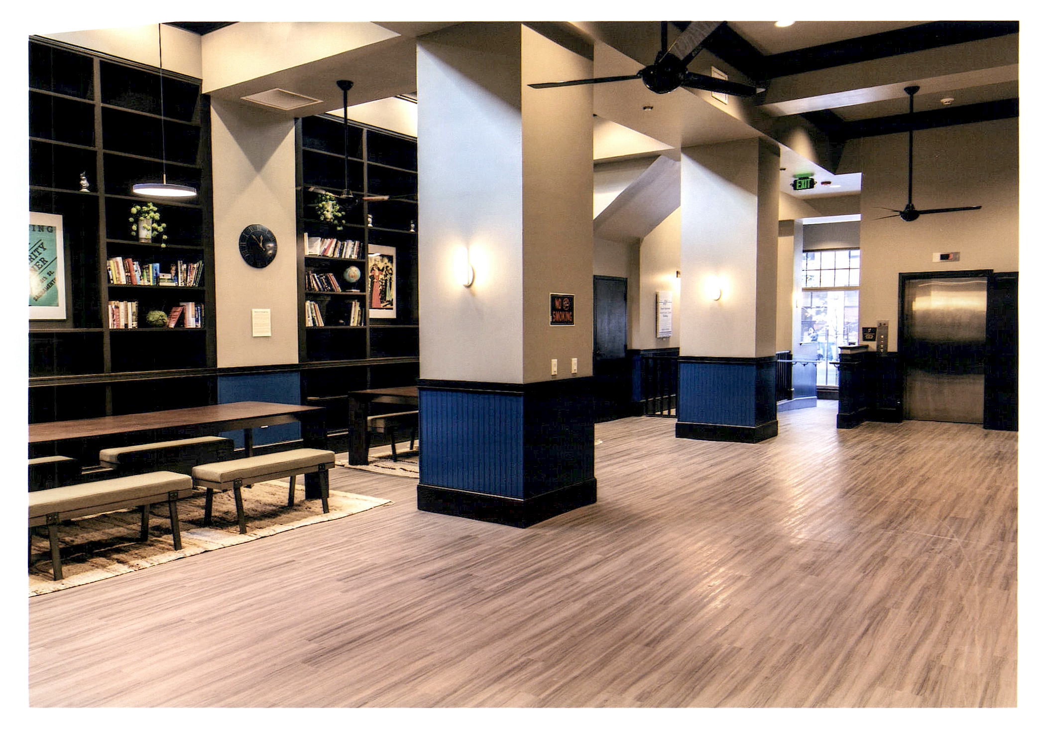 After: another wide view of the lounge and lobby showing the main entrance and the elevator.